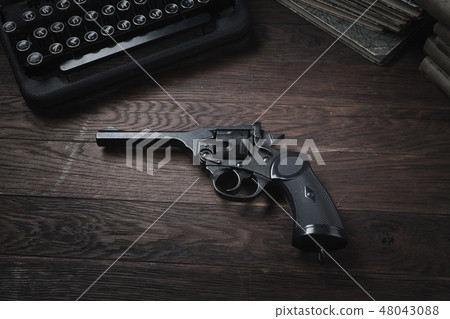 Crime fiction old retro vintage typewriter and gun Crime fiction old retro vintage typewriter and gun 48043088