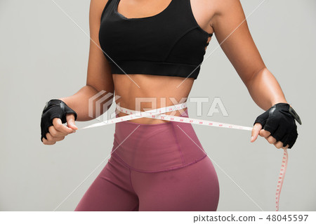 Fitness woman exercise measurement tape waist Fitness woman exercise measurement tape waist 48045597