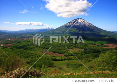 Mt. Yotei in early summer and the Niseko mountain range behind Mt. Yotei in early summer and the Niseko mountain range behind 48049510
