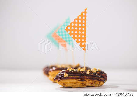 Food, desserts and bakery concept - Eclairs with chocolate decorated as a ship 48049755