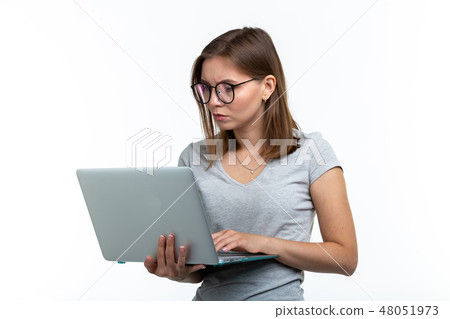 Study, education, people concept - young smart woman in glasses texting something on laptop Study, education, people concept - young smart woman in glasses texting something on laptop 48051973