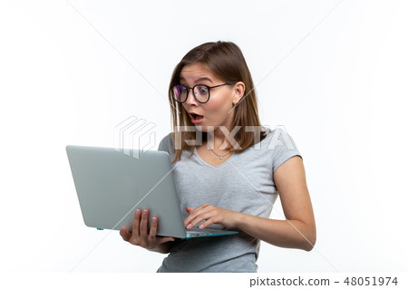 People and education concept - Surprised student woman holding a laptop over white background 48051974