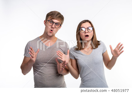 People and education concept - Two young funny student with thoughtful faces over white background People and education concept - Two young funny student with thoughtful faces over white background 48051977