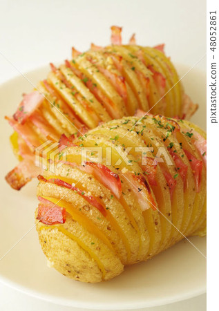 Hassel back potato with bacon in between Hassel back potato with bacon in between 48052861