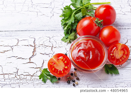 Tomato ketchup sauce on wooden background Tomato ketchup sauce on wooden background 48054965