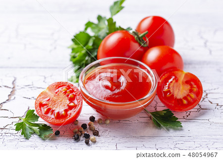 Tomato ketchup sauce on wooden background Tomato ketchup sauce on wooden background 48054967