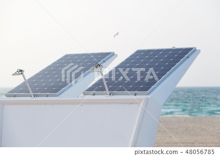 Photovoltaic panel on top of shower standing on the beach 48056785