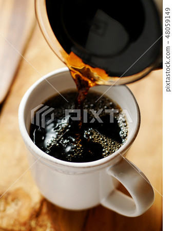 Coffee poured into a mug 48059149