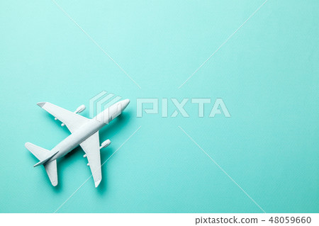 White passenger plane on green mint background. Copy space for text. 48059660