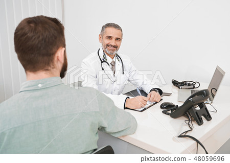 Doctor consulting patient in medical cabinet. 48059696