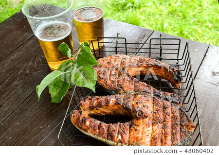 Grilled salmon steak. Two glasses with beer. Grilled salmon steak. Two glasses with beer. 48060402