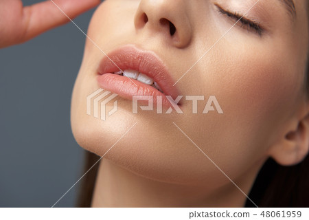 Attractive girl with slightly opened lips isolated on blue-gray background 48061959
