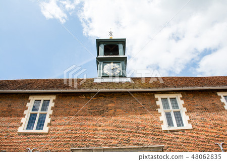 Red brick building with clock tower on the outskirts of the UK Red brick building with clock tower on the outskirts of the UK 48062835