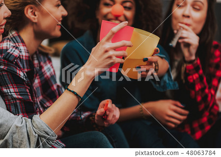 Cheerful young women creating celebration with alcoholic beverages 48063784