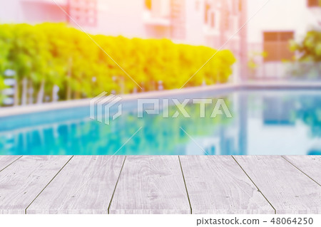 Wooden table with pool summer background. 48064250
