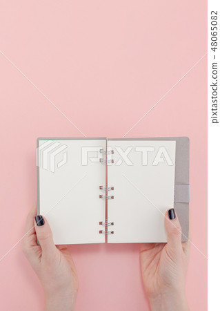 Woman hands with blank notepad mockup Woman hands with blank notepad mockup 48065082