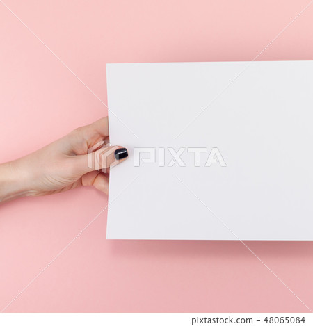 Woman hands with blank A4 paper sheet mockup 48065084