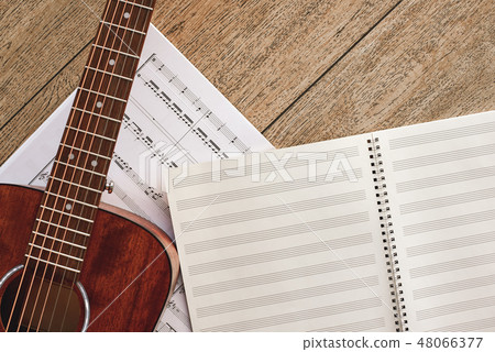 Music for Guitar. Top view of guitar and musical notes laying on the wooden floor 48066377