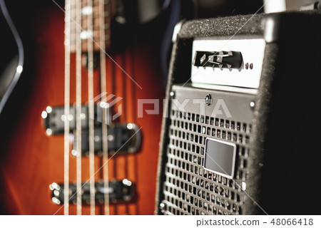 Just perfect sound. Close up view of a brown electric guitar and amplifier standing in audio Just perfect sound. Close up view of a brown electric guitar and amplifier standing in audio 48066418