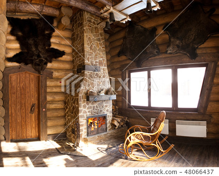 country style interior in hunter chalet with fireplace 48066437