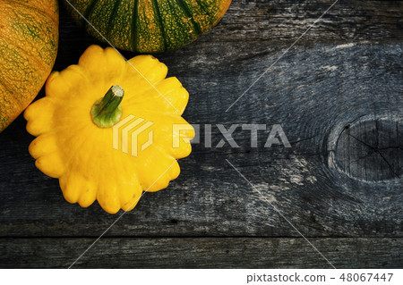 Pumpkin and peter pan squash on wood 48067447