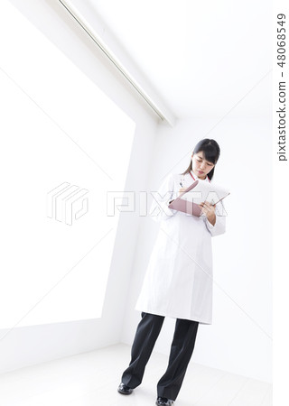 Image of a doctor wearing a white suit Image of a doctor wearing a white suit 48068549