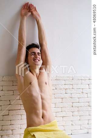 young fit smiling man stretching at home kitchen young fit smiling man stretching at home kitchen 48069510