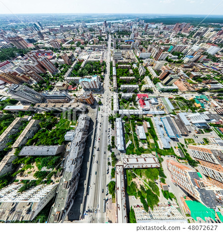 Aerial city view with crossroads and roads, houses, buildings, parks and parking lots. Sunny summer Aerial city view with crossroads and roads, houses, buildings, parks and parking lots. Sunny summer 48072627