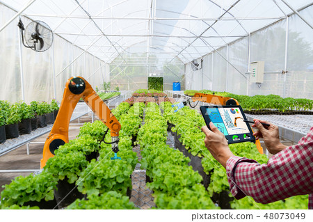 Farmer holding a tablet smart robotic harvest 48073049