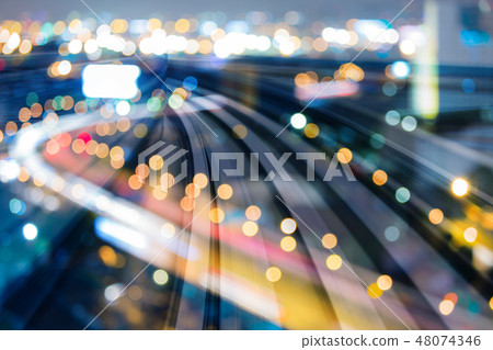 Speedy train track over blur city light 48074346