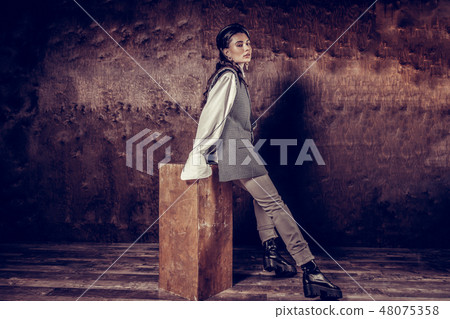 Pleasant attractive woman leaning on the stool Pleasant attractive woman leaning on the stool 48075358
