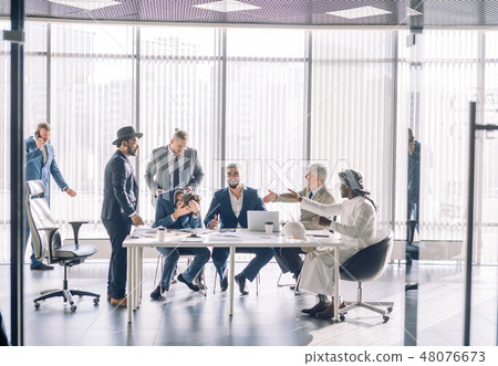 Multiracial partners dispute at negotiations, having fun while settling conflict 48076673
