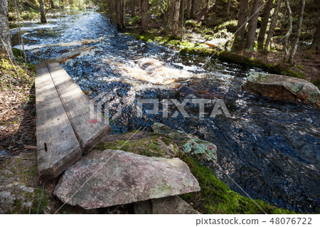 Flooding river and broken duckboards Flooding river and broken duckboards 48076722