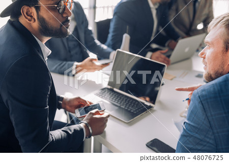 Casually dressed male colleagues at a meeting, close up 48076725