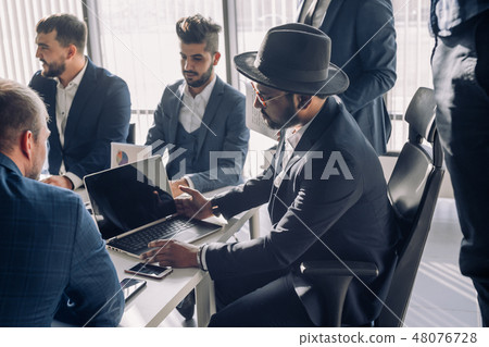Casually dressed male colleagues at a meeting, close up Casually dressed male colleagues at a meeting, close up 48076728