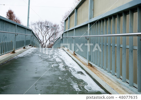 Pedestrian bridge where snow was piled up Pedestrian bridge where snow was piled up 48077635