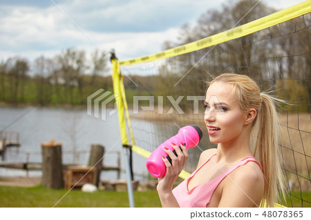 Sports games and people concept. Young woman in sportswear volle 48078365