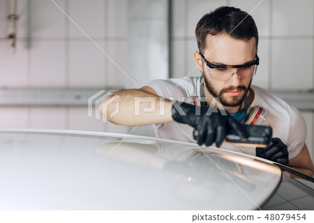 measurements of painting thickness. mechanic measuring the paint thickness measurements of painting thickness. mechanic measuring the paint thickness 48079454