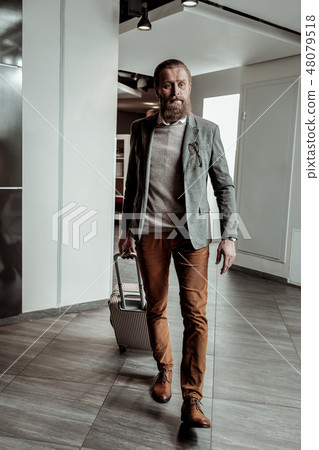 Handsome bearded businessman looking forward at reception 48079518