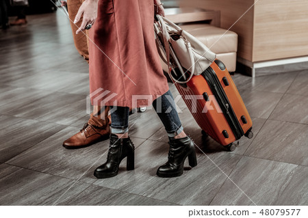 Delighted young couple having business trip together Delighted young couple having business trip together 48079577