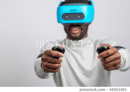 Young african man wearing virtual reality goggles isolated on white background 48081061
