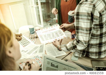 Students looking at their schedule while having group meeting Students looking at their schedule while having group meeting 48081559