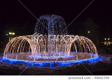 fountain holiday garlands glittering in city park 48082399