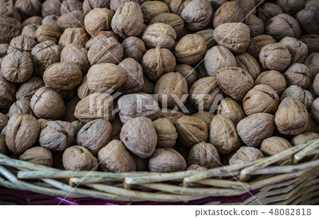 Background of a walnut in a wicker basket close-up Background of a walnut in a wicker basket close-up 48082818