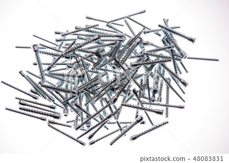 Mound of furniture screws top view on white background 48083831