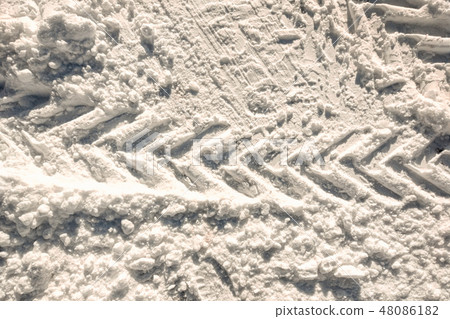 Vehicle and tractor tire tread imprints on snow Vehicle and tractor tire tread imprints on snow 48086182