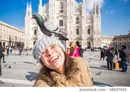 Italy, excursion and travel concept - young funny woman taking selfie with pigeons in front of 48087665