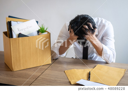 Stressed businessman will being resignation and packing belongin 48089228