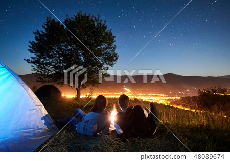Couple tourists resting at night camping under stars 48089674