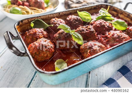 Meat beef balls with basil in vintage roaster pan. Meat beef balls with basil in vintage roaster pan. 48090162